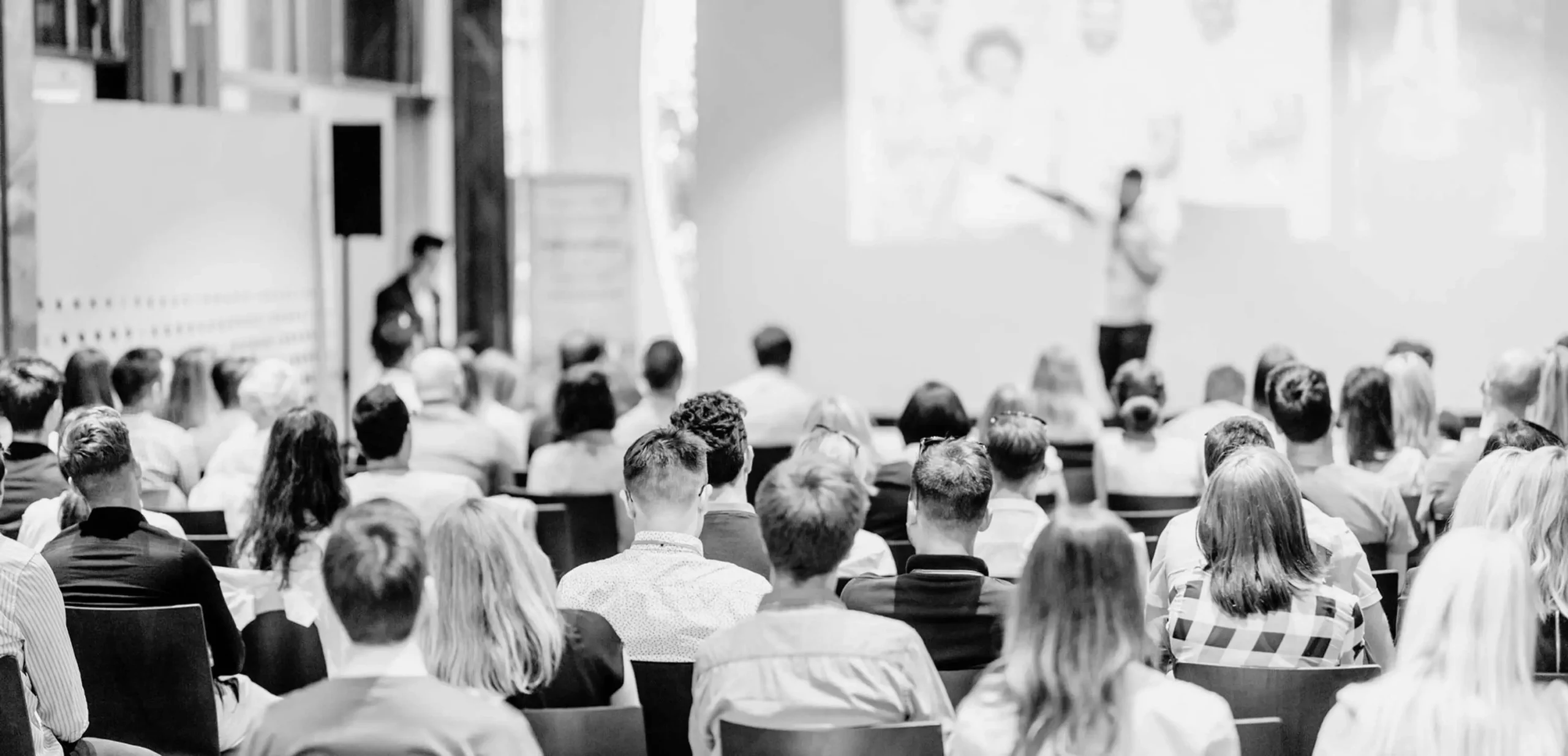 Conference presenter engaging with an audience.